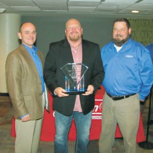 Mike Duncan and Jeff Trotter, Johnstone Upstate, awarding Kendall Smith of Priority Heating and Air