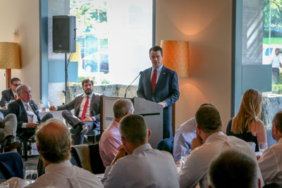 Senator Todd Young, at podium, addressing industry leaders, including Bud Mingledorff (far left)