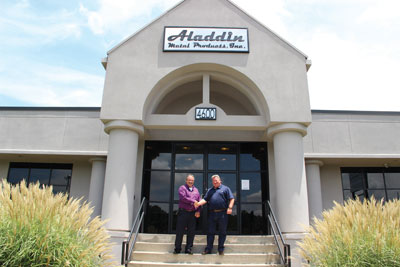 Pepper Norris and Clayton Barnes in front of the new Aladdin Metal Products facility in Forest Park, Georgia.