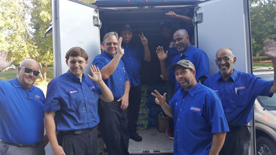Staff of ARS/Rescue Rooter Atlanta pack up a service truck.