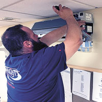 Paradigm Project Manager Richard Nimmo installs the iWave-M on the Fujitsu wall head.