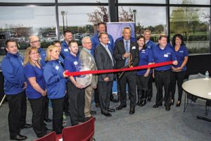 Uponor North America President Bill Gray proudly celebrates with the Hutchinson Ambassadors at the ribbon cutting of the new Hutchinson plant.