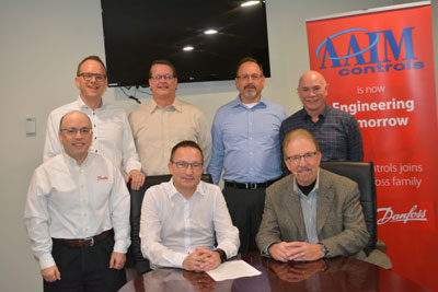 Front row (left to right): Brian Davis, senior director, sales development – industrial automation, North America, Danfoss Cooling; Kristian Strand, president – refrigeration and A/C controls, Danfoss Cooling; Arthur Marshall, co-founder and president, AAIM Controls. Back row (left to right): Henrik Moller Henriksen, director of strategic programs – refrigeration and A/C controls, Danfoss Cooling; Pat Ocker, power engineering manager, AAIM Controls; Craig Cordell, PLC engineering manager, AAIM Controls; Alan Izer, co-founder and vice president of operations, AAIM Controls.