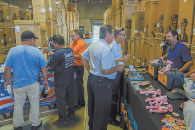 Lennox customers speak with John Galloway (red shirt) of PED Associates and Michael Cupp (far r.) of Cain Sales.