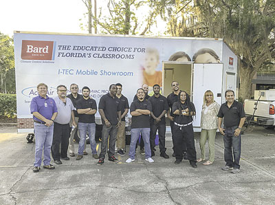 Frank Suranyi (l.) and Penny Anderson (2nd from r.) with FCC instructors and students in front of the AccuAir mobile showroom.