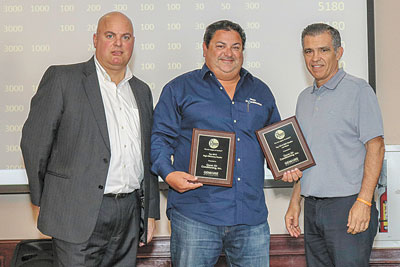 Danny Puig (c.) of Oscar AC accepts the Rheem 2018 Top High Efficiency Dealer and 1st Place RNC Dealer Awards from Alex Amigorena and Pete Perez of Gemaire Distributors.