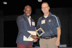 Chris Bright Apprentice of the Year Award recipient Mr. Kertus Gilbert is congratulated by Apprenticeship Program Coordinator Emery Cary.