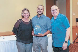 Abanoub Zakhra (c.) accepts the 2019 FL HVAC Insider Journeymen of the Year Award from FACAA Office Manager Rhonda Hutchison and FL HVAC Insider editor Peter Montana.