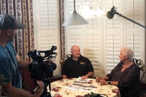Rusty Tensfield (black shirt), president, Rusty Tensfield Heating & Cooling, Manchester, Tenn., presents homeowner Ceresia Cummings with info on her new Frigidaire split-system air conditioner installation that Lifetime TV’s Designing Spaces production crew documented from start to finish.