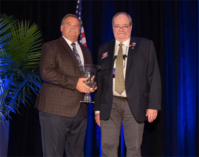 Jim Steinle, left, receives Col. Scott award from PHCC President Ken Nielsen.