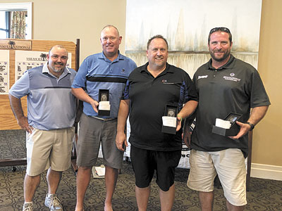 Golf tournament committee chairman Curtis Miccichi (l.) joins three of the 2nd place Complete Comfort Services team members.