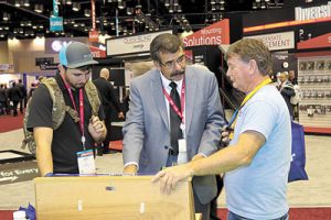 Robert Scaringe (c.) of Mainstream Engineering/QwikProducts describes the QwikSwap boards to Ben Moore (l.) and Rich Rutherford Jr. of Rich’s Irrigation, Cooling and Heating.