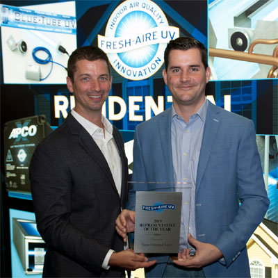 Left to right: Fresh-Aire UV’s Sean Moseley, vice president—residential sales, presents Nick Vosburgh, president, Value Oriented Sales (VOS), Miami, with the 2019 Rep of the Year award at the International Air-Conditioning, Heating and Refrigerating Exposition (AHR Expo 2020) Feb. 3 in Orlando.