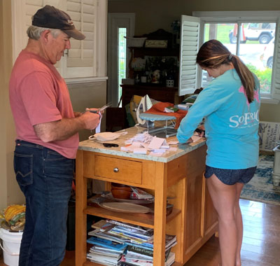 Wayne Raper, MGM Products CEO, and team member Kendyll Brown assembling materials for handmade face masks.