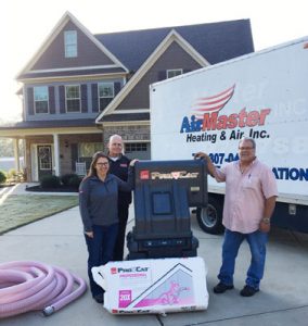 Pictured with the Owens Corning Pro-Cat Professional Loosefill Insulation System is: Nicole Montoleone, District Sales Manager for Owens Corning; Bill Eaton, Regional Sales Manager for East Coast Metal Distributors, Inc.; and Gary Presti of Air Master Heating & Air Inc.