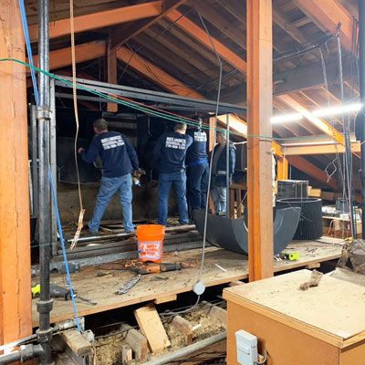 Reliance Heating and Air working in the attic during their installation of the new Fugitsu units.