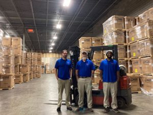 Sam Davis, Ken Graybill, and Marvin Coates show off their extensive warehouse facility in Forest Park. Not Pictured: David Leavell, Marcus Aimes.