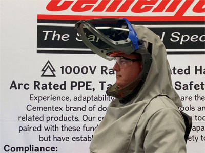 A lift-front face shield integrated into arc flash PPE hood from Cementex.