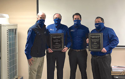 Jim Luce (president of LSK), far left, with the LSK DSG team (left to right) Pete Sacca, Michael Ducane and Anthony Zotto, celebrating their award at the LSK Air Mitsubishi training center