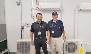 Jeff Thompson, APR VP Dealer Product (left) Ed Howell, APR Technical Service Advisor (right) Pictured in front of the APR donated Fujitsu and Friedrich Ductless units.